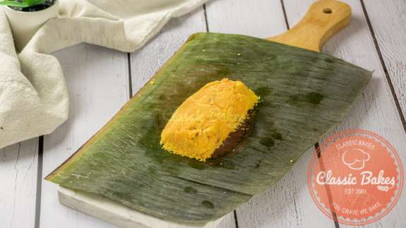 Paime filling being folded in a banana leaf 