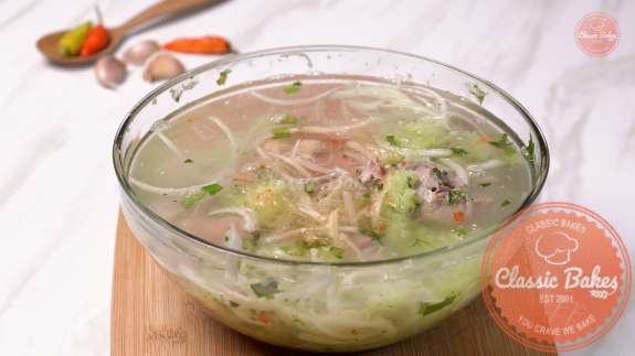Pigs foot souse with water being added to the bowl 