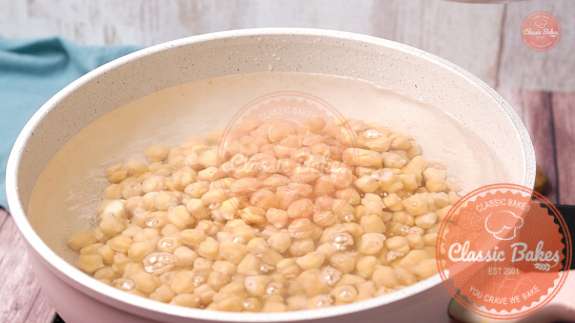 A pot of chickpeas being boiled in a pot 