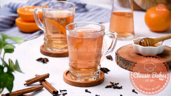 Sideview of mugs containing orange peel tea 