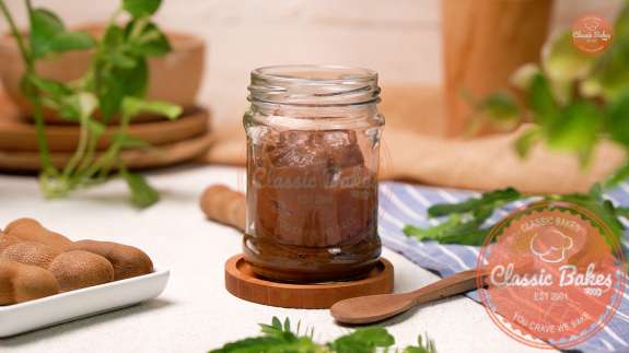 Tamarind paste in a glass jar on the countertop 