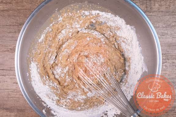Wet and dry ingredients being mixed in a bowl 
