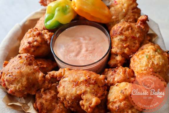 Bahamian conch fritters with dipping sauce in the middle