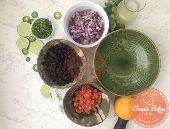 Areal view of cranberry salsa ingredients next to a bowl