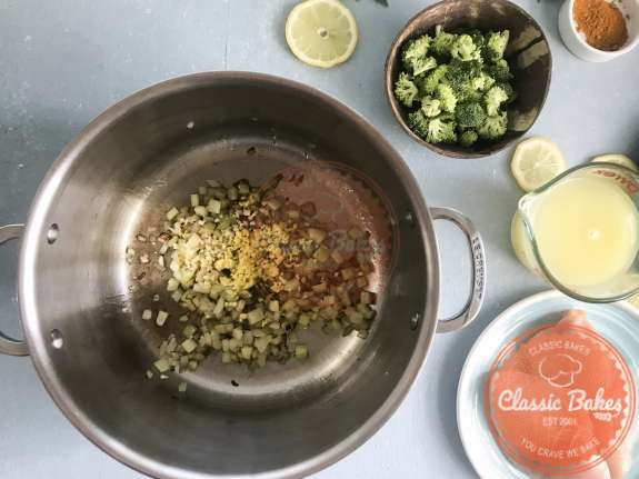 Areal view of garlic and ginger being added to a pot 