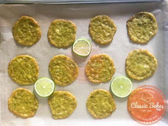 Avocado chips cooling down on a sheet tray. 