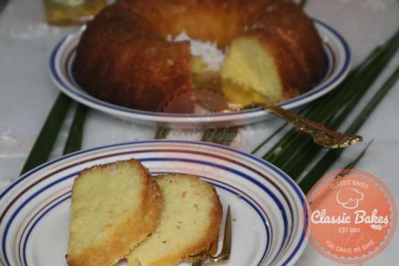 Coconut rum cake on a serving plate. 