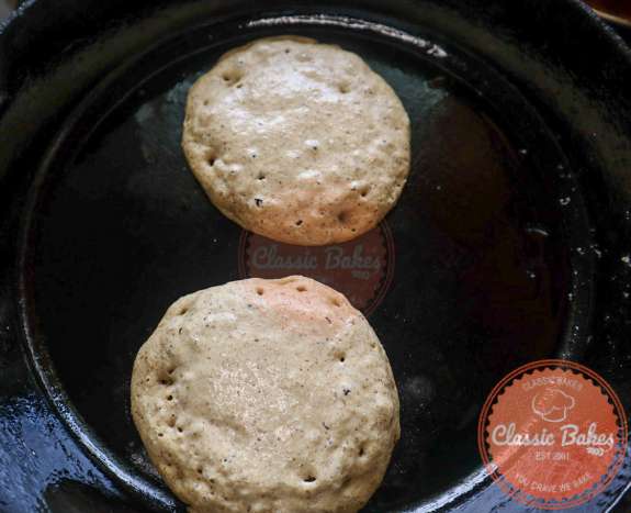 Flourless banana pancakes cooking in a skillet.