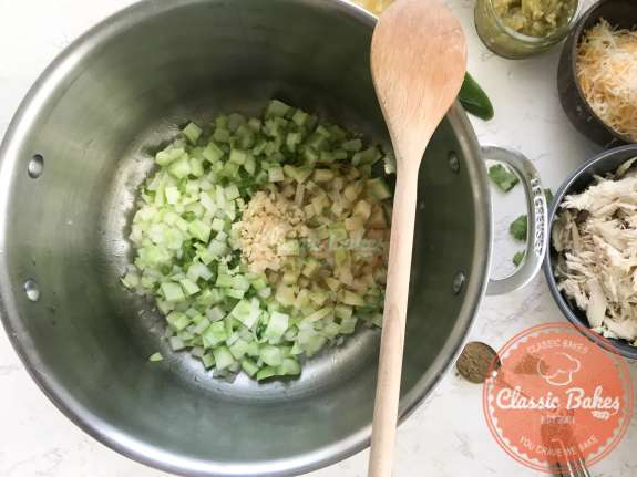 Garlic added to a pot of keto white chicken chili 