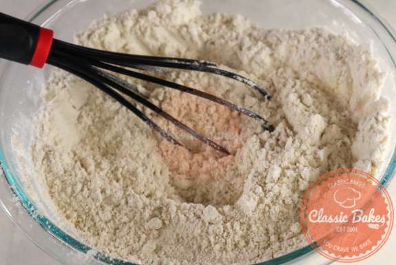 Gluten-free flour, sugar-free sweetener, cinnamon, cardamom, and salt whisked together in a bowl. 