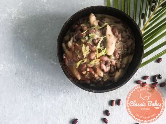 Close up shot of Jamaican Stew Peas in a bowl with peas on the sides