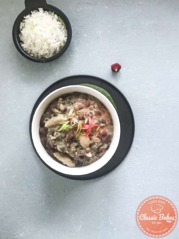Overview of a bowl of Jamaican Stew peas next to a bowl of rice 