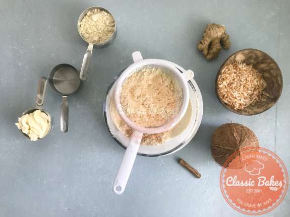 Overview of gluten free flour being sifted into a bowl 