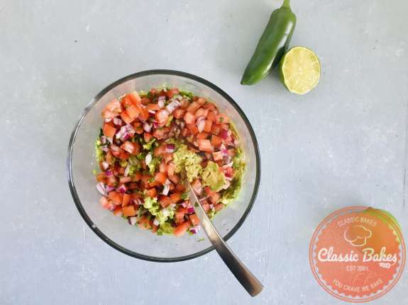 Overview of Guacamole salsa being mixed in a bowl 