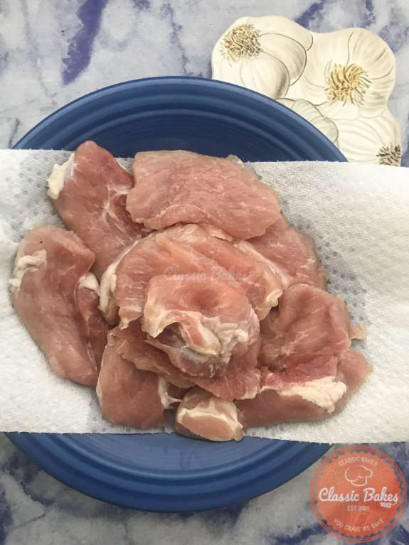 Overview of salt pork on a plate with paper towel 
