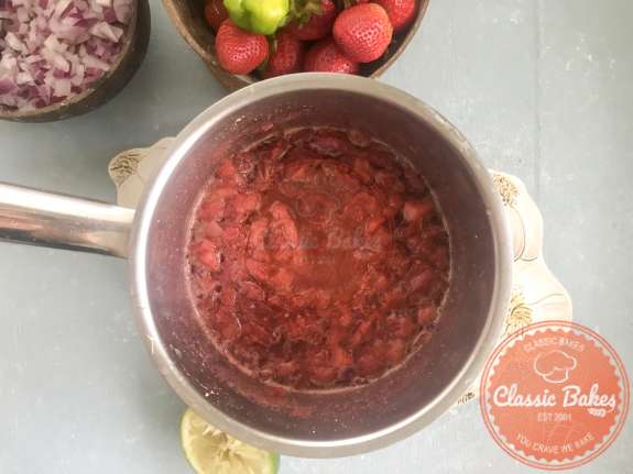 Overview of strawberry chutney with lime juice being added to it 