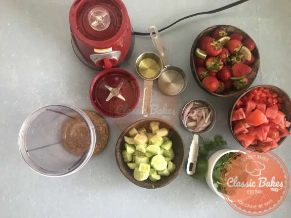 Overview of strawberry Soup ingredients lined up next to a blender