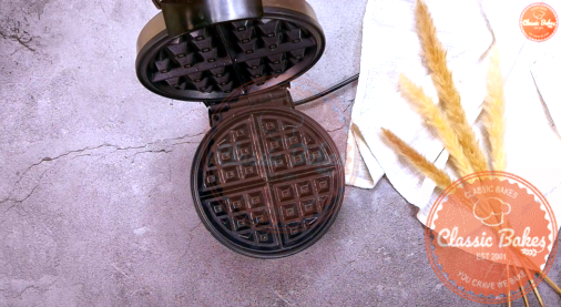 Overview of a waffle iron heating up on a countertop 