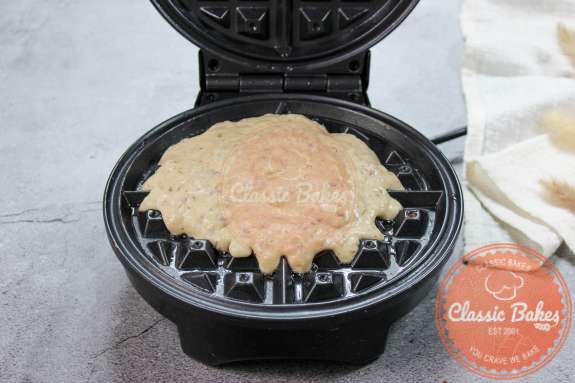 Waffle batter being added to a waffle iron