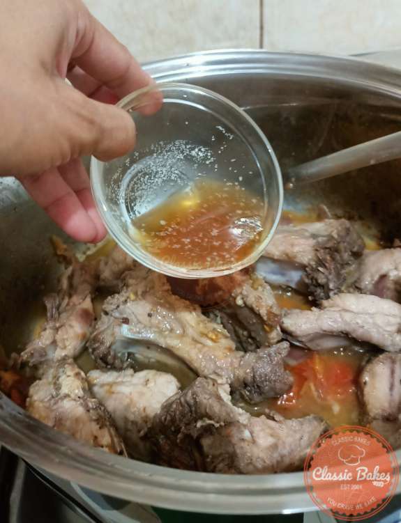 Adding of Fish sauce in the pot with pork