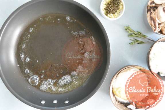 Aerial of a pan heating up with olive oil and butter inside 