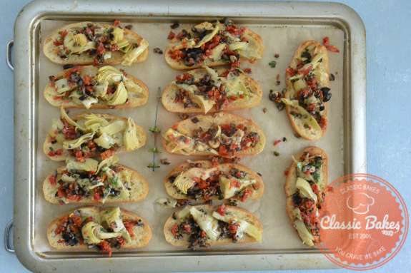 Aerial view of a tray line up with artichoke bruschetta 