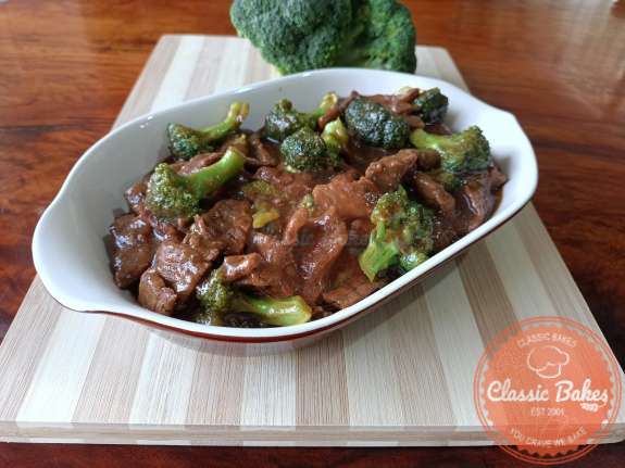 Frontal view of a plate of instant pot beef an broccoli on a tabletop 