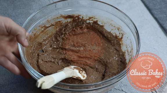 Milk, oil, vanilla extract, flaxseed mixture added to dry mixture and mixed sufficiently in a bowl
