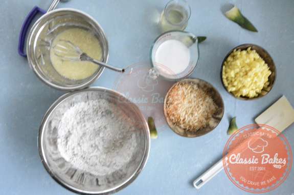 Overview of a bowl containing coconut milk, eggs and coconut oil being mixed using a whisk 