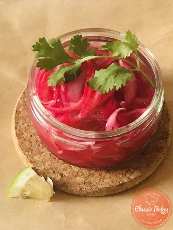 Close up shot of Pickled Red Onions Mexican in a glass