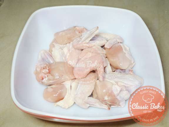 Raw chicken wings in a mixing bowl