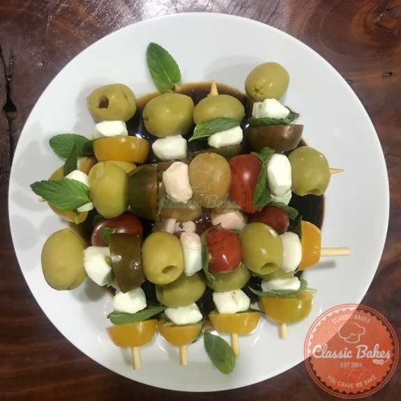 Close up of a plate of caprese skewers 