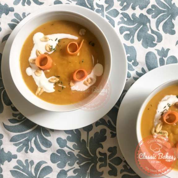 Carrot, sweet potato ginger soup with coconut milk and peanut garnish 