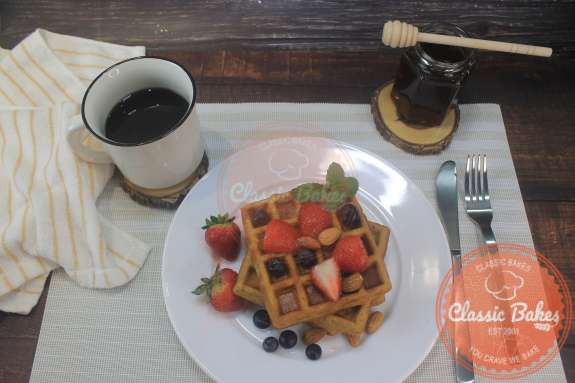 Carrot Waffles topped with strawberries, blueberries and almonds best with coffee or tea