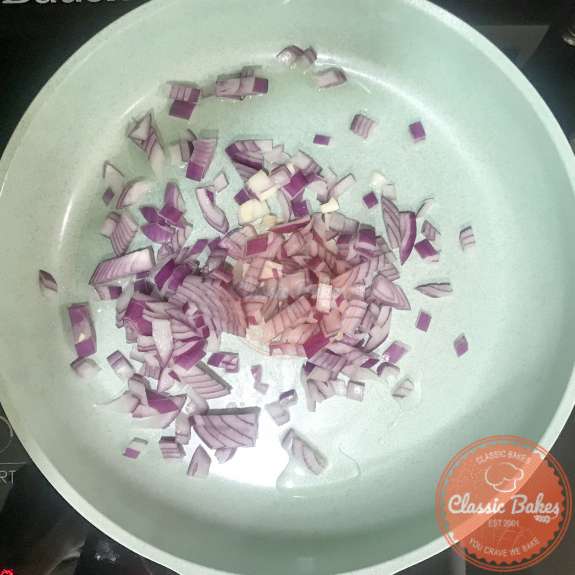 Diced red onions sauteing in olive oil 