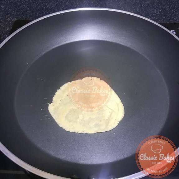 A low carb-corn tortilla cooking in a pan 