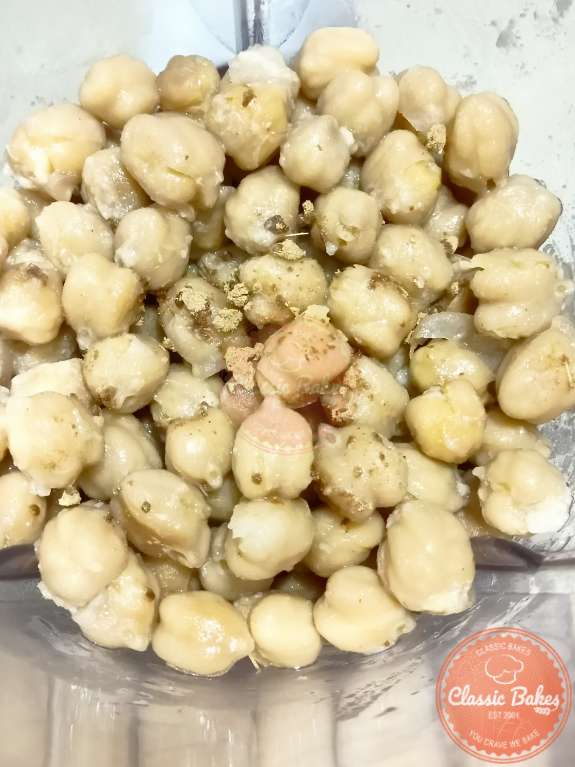 Mixing chickpeas with the garlic lemon mixture