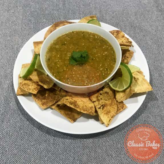 Overview of a bowl of tomatillo red chili salsa and tortilla chips 