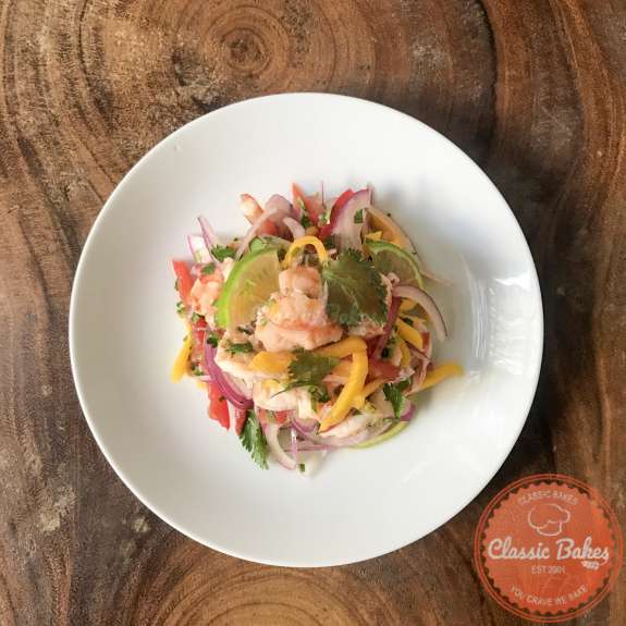 Overview of plated shrimp ceviche on a wooden table 