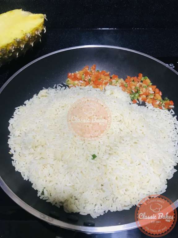 Side view of rice being fried in a pan 