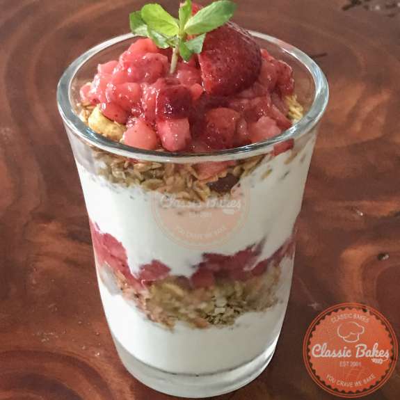 Side view of a strawberry parfait in a glass