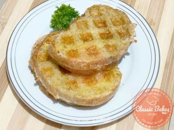 Overview of a grilled cheese that was cooked in a waffle iron on a plate 
