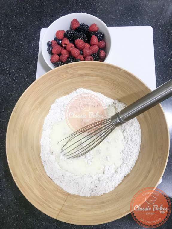 Wet and dry pancake ingredients being mixed in a bowl 