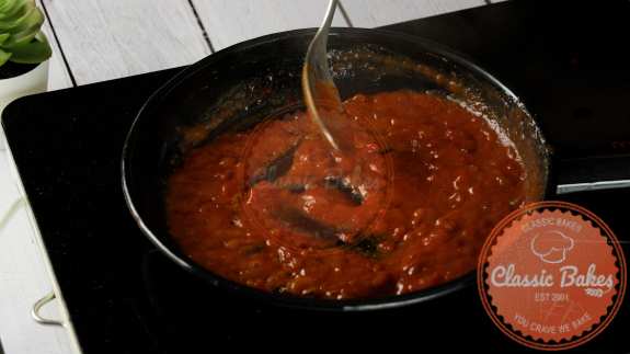 Buffalo sauce simmering in a saucepan