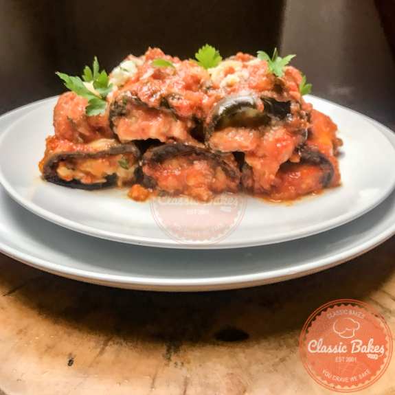 Side view of a plate of eggplant roll ups