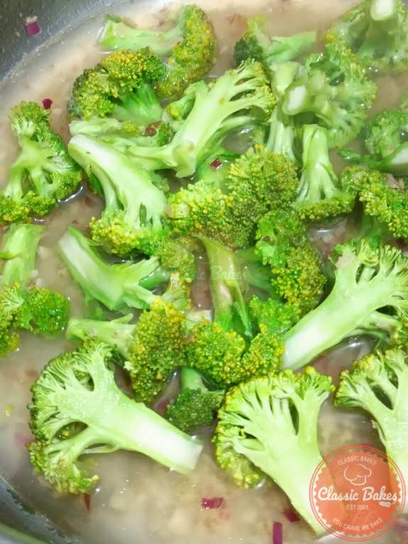 Adding broccoli, juice and broth