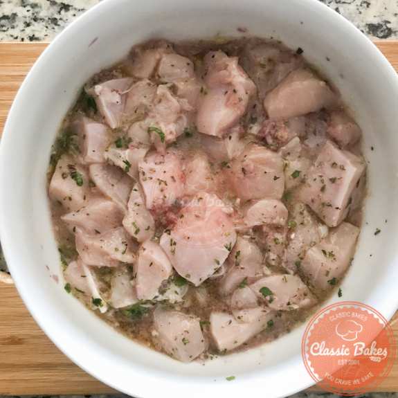 Chicken mixed with marinade in a bowl 