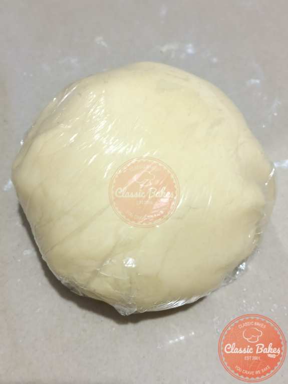 Forming dough into ball put in plastic wrap.