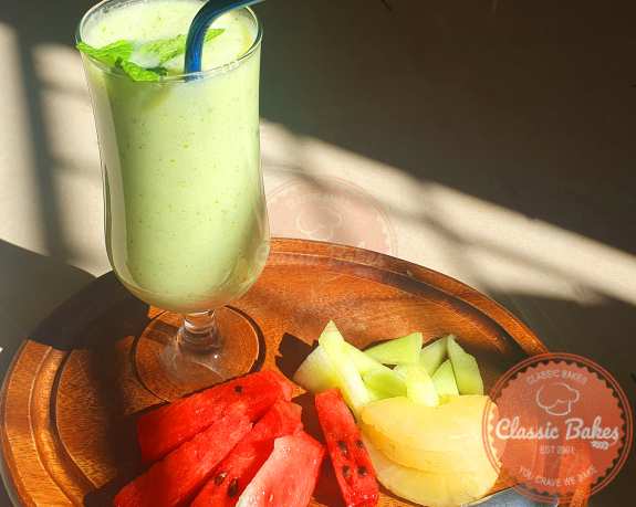 Honeydew Smoothie with watermelon, pineapple, and honeydew melon on the side afternoon snack