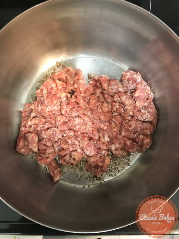 Sausage being added to a pot 